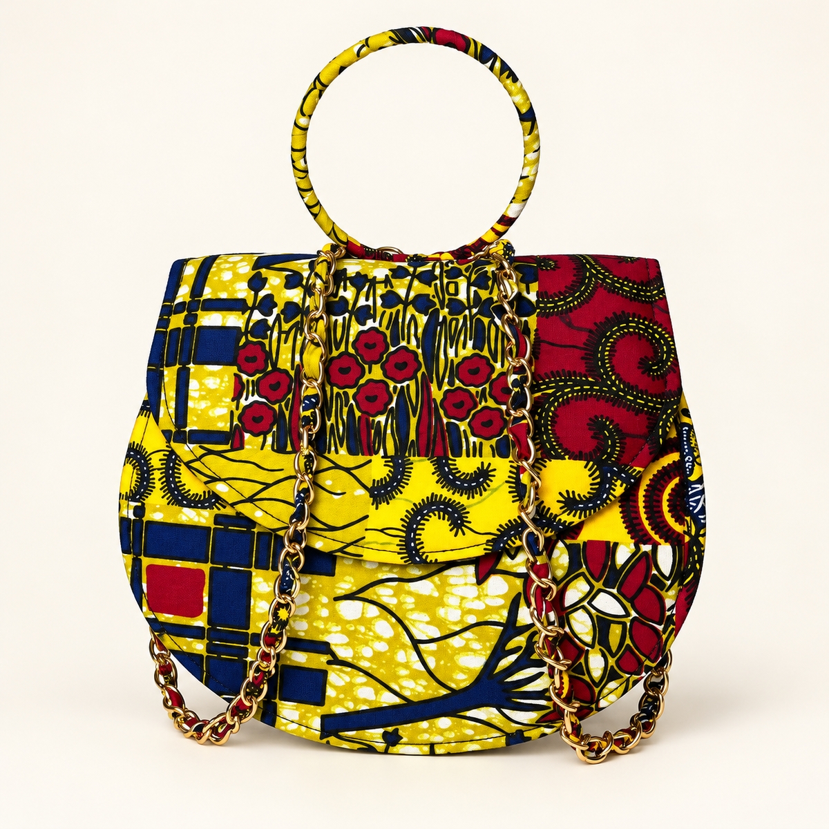 Syda African print Ankara handbag in yellow, burgundy and navy with circular handle and gold-tone chain.