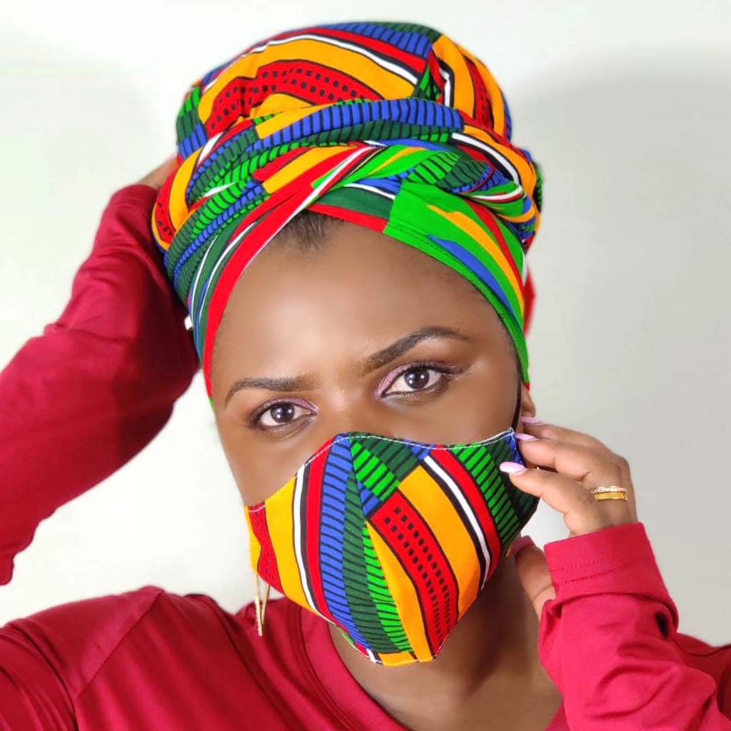 Woman wearing a colorful headscarf and matching face mask against a white background