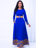 Woman wearing a blue dress with yellow accents on a white background