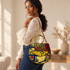 Syda African print Ankara handbag in yellow, burgundy and navy with circular handle and gold-tone chain.