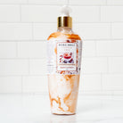 A bottle of Vanilla Chai Body Lotion with a rich, creamy formula, infused with warm vanilla, cinnamon, and cardamom for deep hydration.